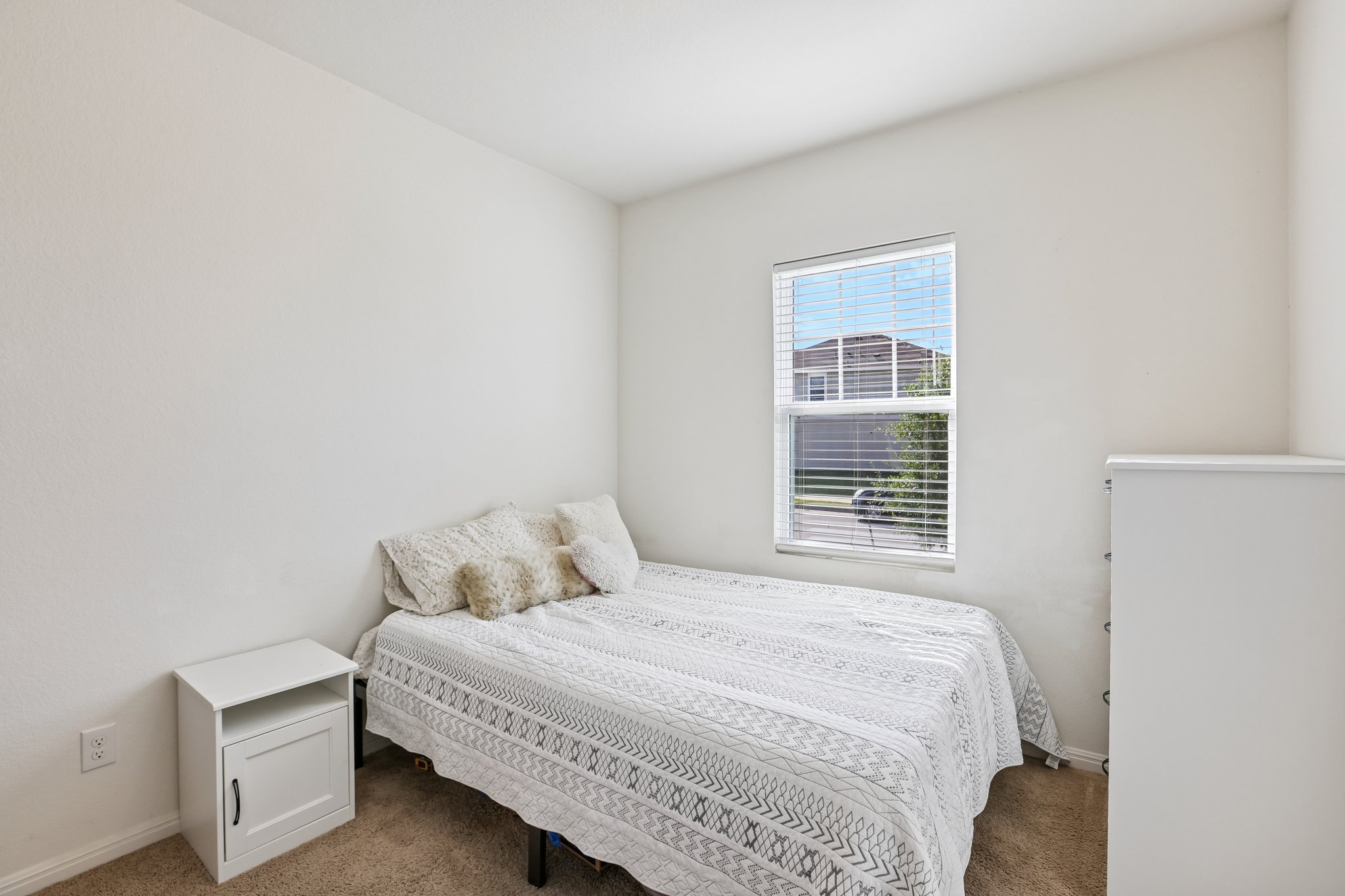 19105 Mike Mansfield Road Manor, TX 78653 - Photo 19 of 28 Front bedroom with soft carpeting and a window offering natural light