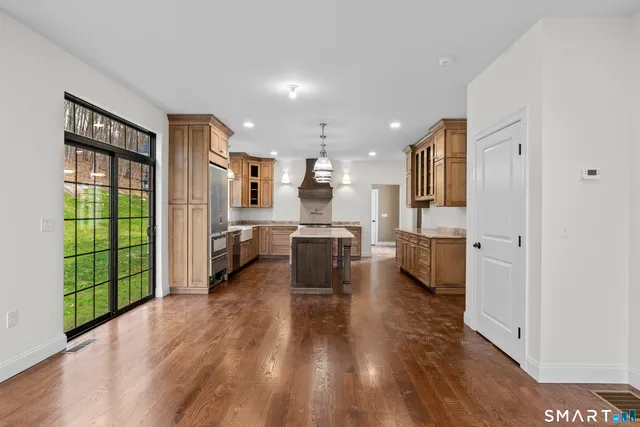 a view of a living room kitchen and a wooden floor