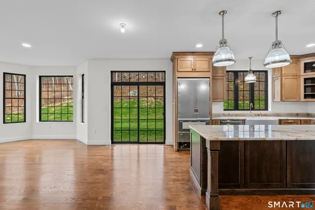 a kitchen with stainless steel appliances granite countertop a stove and a kitchen island