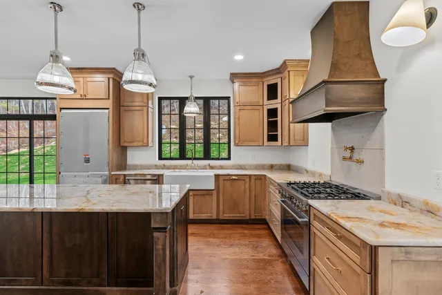 a kitchen with stainless steel appliances granite countertop a stove and a kitchen island