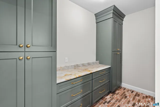 a bathroom with a granite countertop sink and vanity