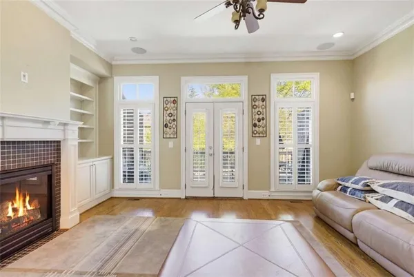 a living room with furniture a ceiling fan and a rug