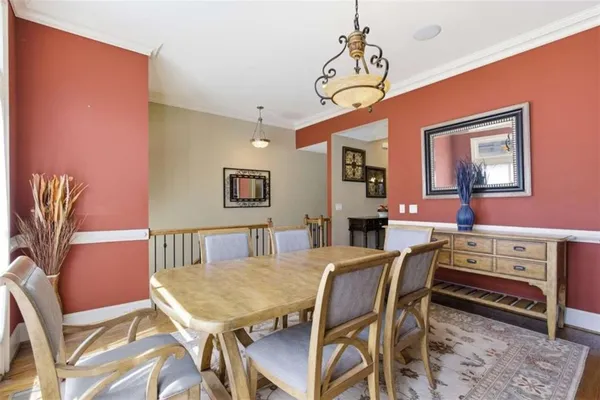 a view of a a dining room with furniture window and wooden floor
