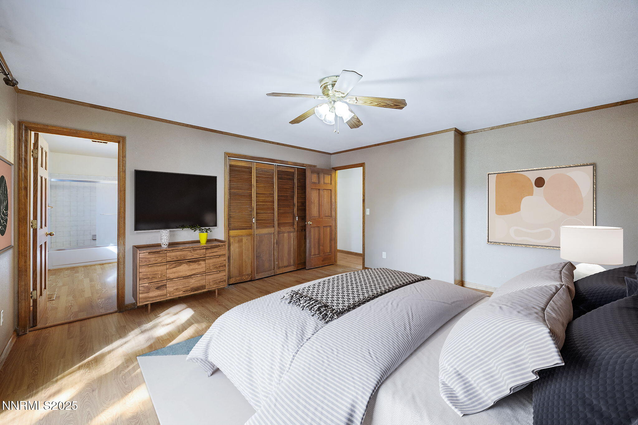2260 Empire Road Reno, NV 89521 - Photo 8 of 49 a bedroom with a bed flat screen tv and a couch