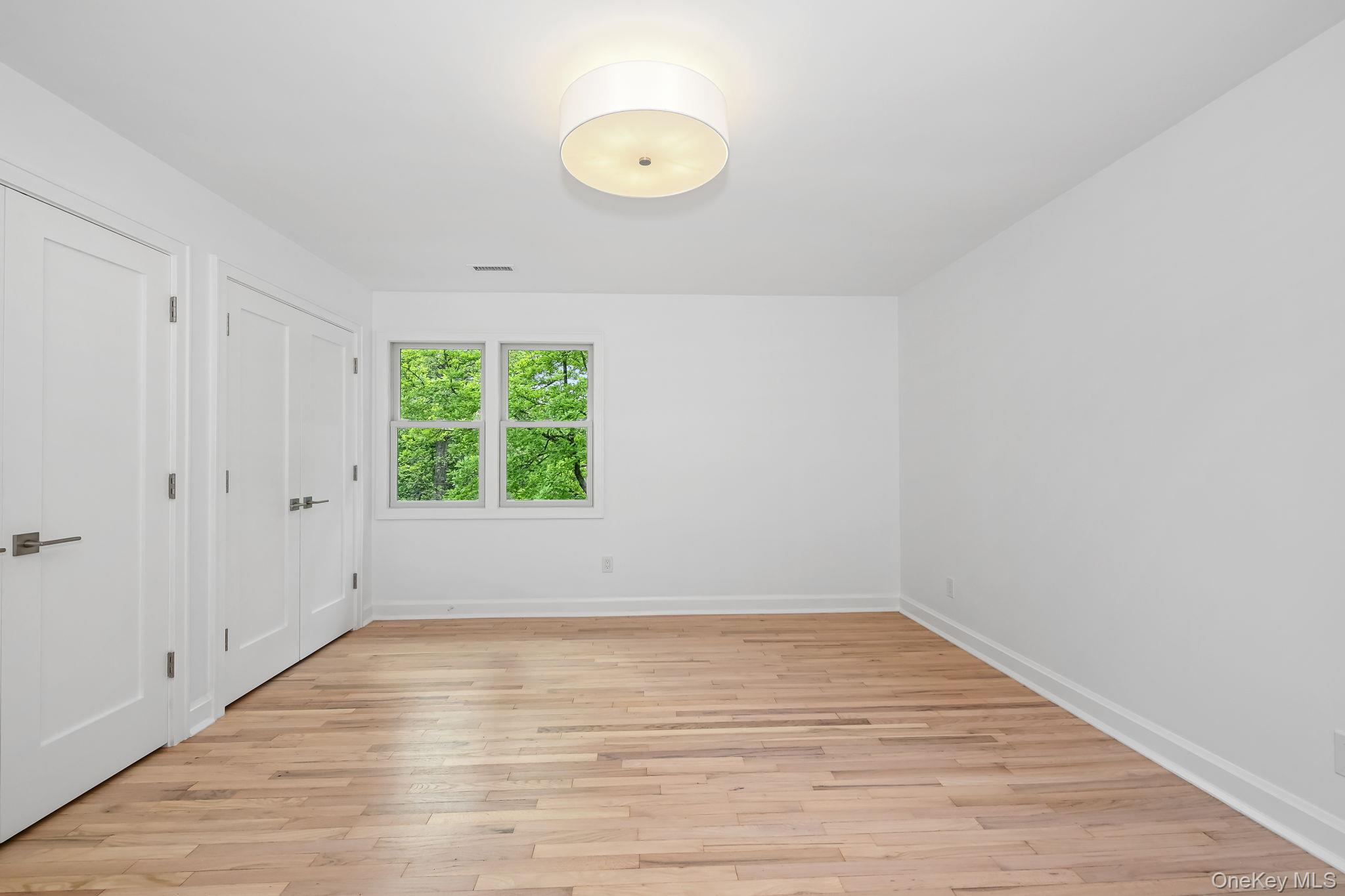 24 Country Road Mamaroneck, NY 10543 - Photo 14 of 37 a view of a room with wooden floor and window