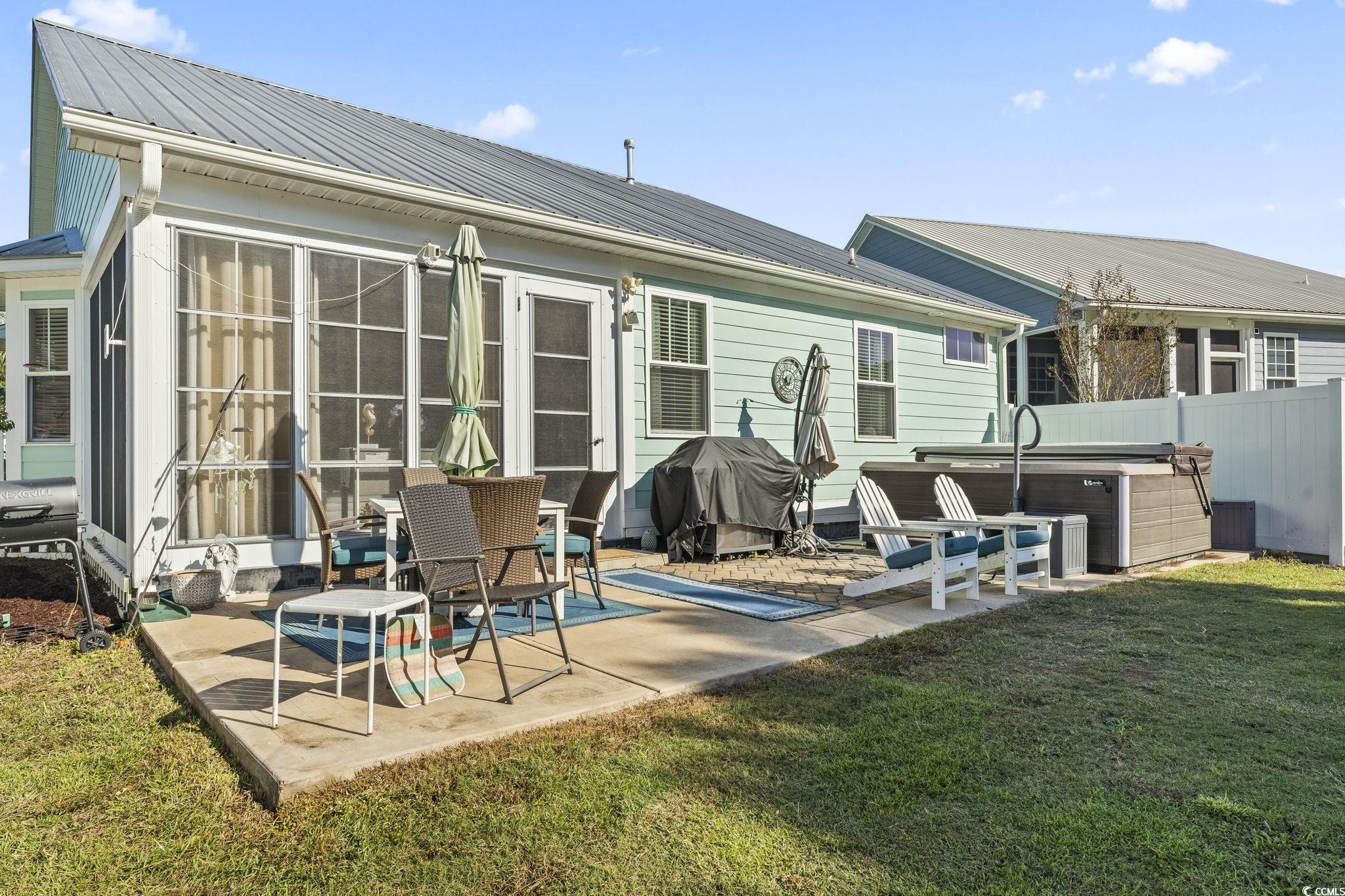 235 Waties Drive Murrells Inlet, SC 29576 - Photo 31 of 39 Rear view of property featuring a sunroom, a yard,