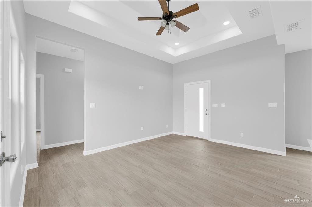 516 Bridget Street Weslaco, TX 78596 - Photo 12 of 24 wooden floor in an empty room with a window