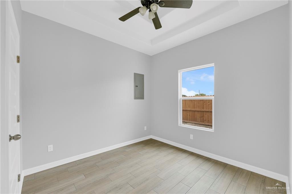 516 Bridget Street Weslaco, TX 78596 - Photo 13 of 24 an empty room with a window and ceiling fan