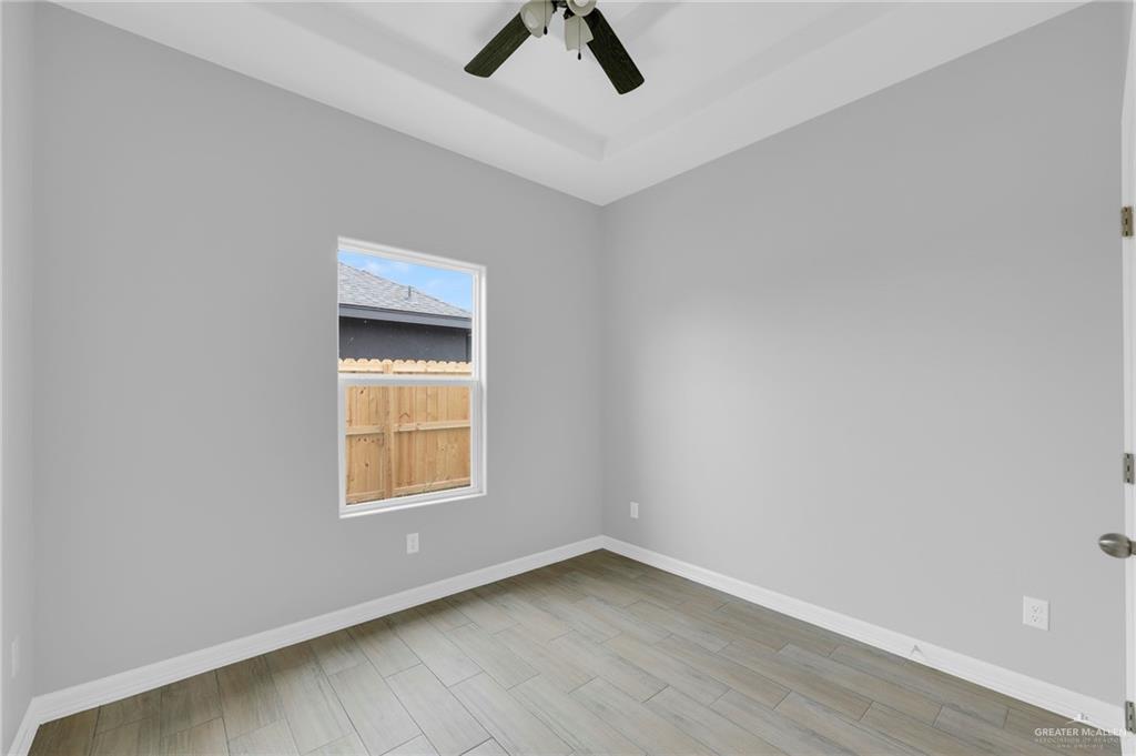 516 Bridget Street Weslaco, TX 78596 - Photo 14 of 24 an empty room with a window and ceiling fan