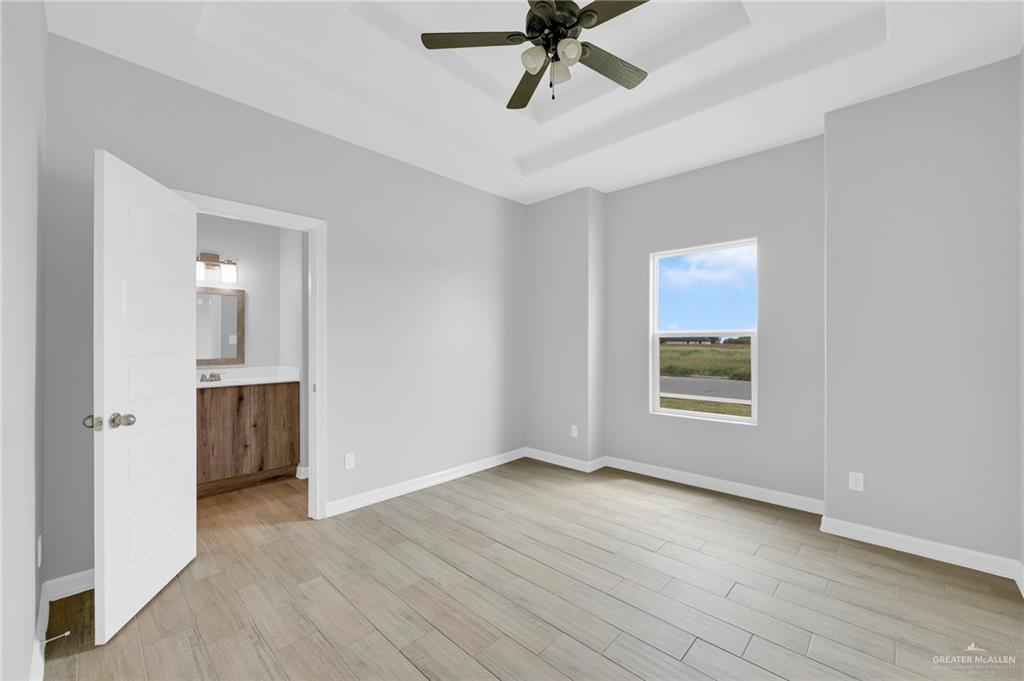 516 Bridget Street Weslaco, TX 78596 - Photo 16 of 24 a view of an empty room with a window and wooden floor