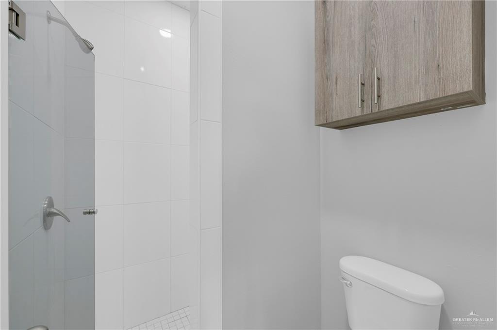 516 Bridget Street Weslaco, TX 78596 - Photo 18 of 24 a white toilet sitting next to a shower