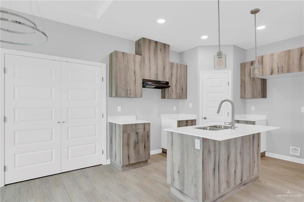 516 Bridget Street Weslaco, TX 78596 - Photo 7 of 24 a kitchen with stainless steel appliances granite countertop a sink stove and refrigerator with wooden floor