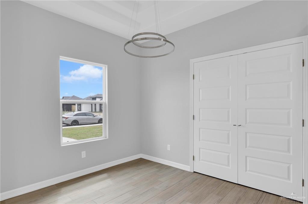 516 Bridget Street Weslaco, TX 78596 - Photo 8 of 24 a view of empty room with window and wooden floor