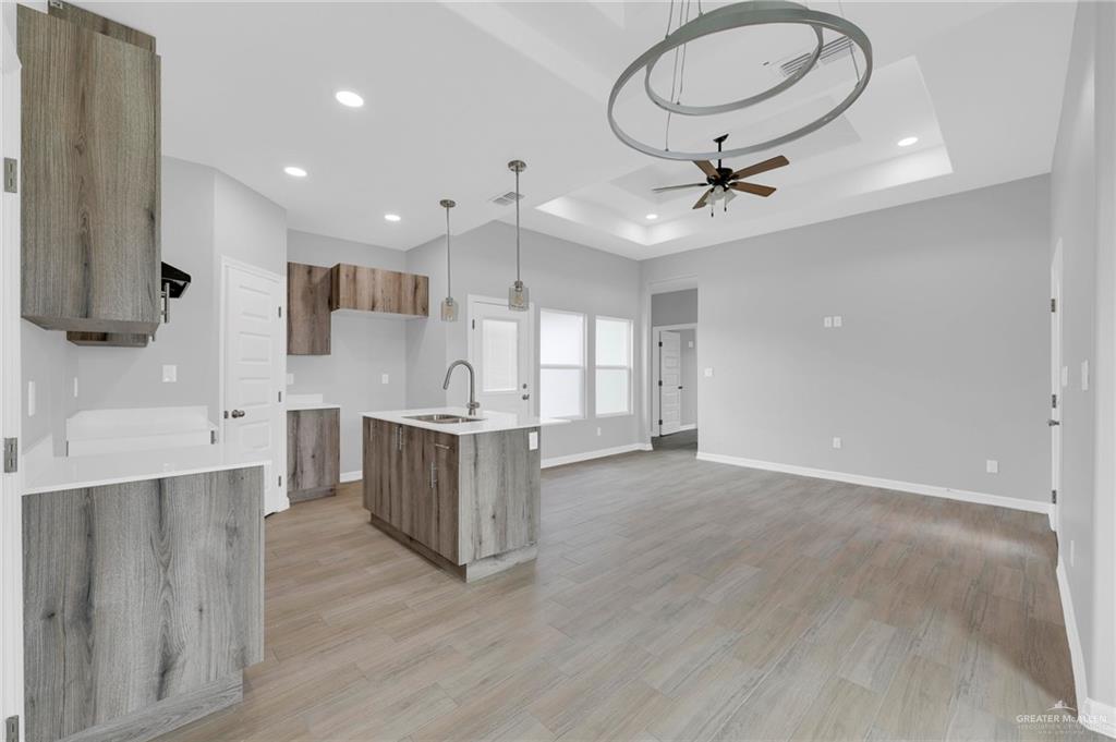 516 Bridget Street Weslaco, TX 78596 - Photo 9 of 24 a large kitchen with stainless steel appliances a large center island attached withe living room