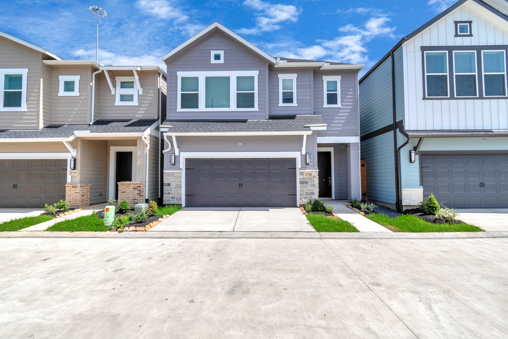 a front view of a house with a yard and a garage
