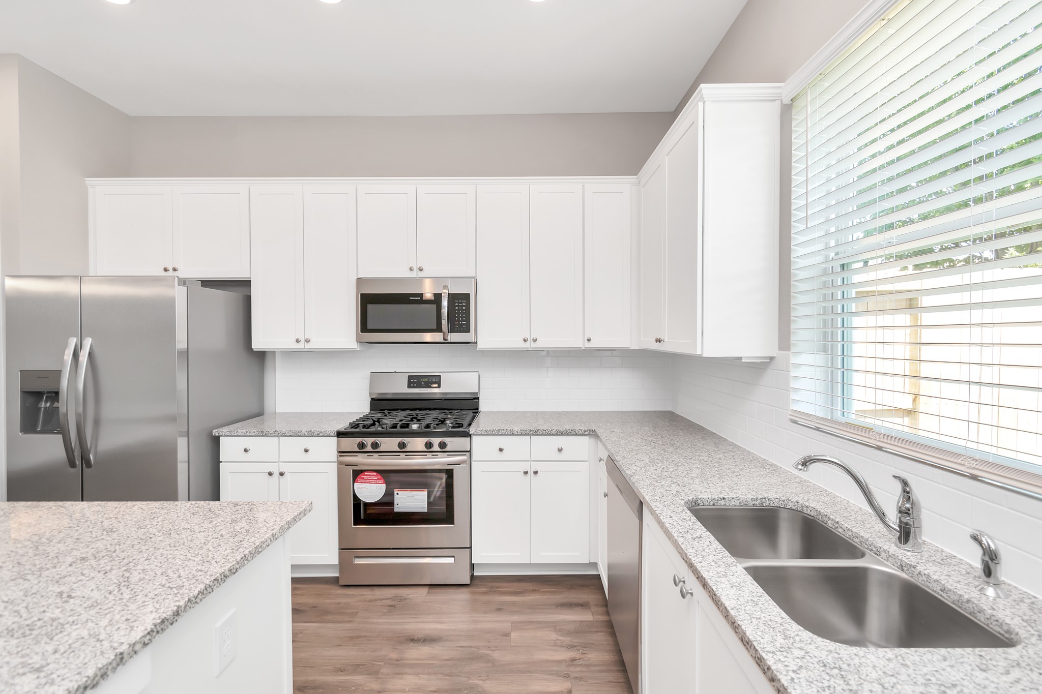 2717 Ruhman Flds Drive Houston, TX 77008 - Photo 38 of 43 a kitchen with granite countertop a sink stove and refrigerator