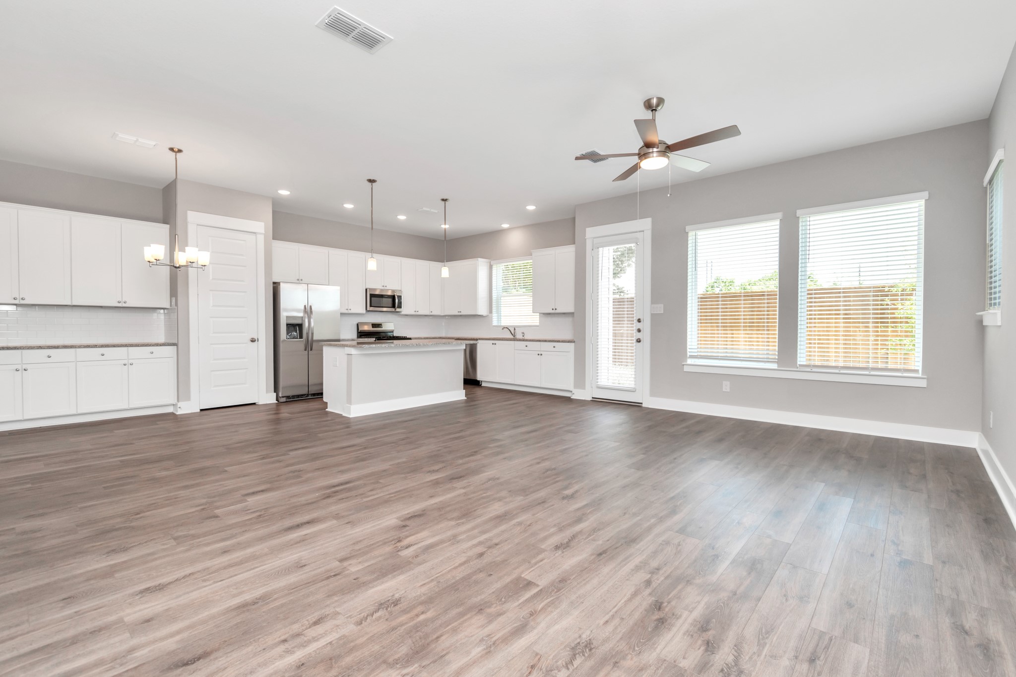 2717 Ruhman Flds Drive Houston, TX 77008 - Photo 42 of 43 a view of a kitchen with a stove cabinets a ceiling fan and wooden floor