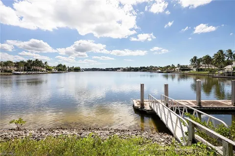 a view of a lake with sitting area and lake view