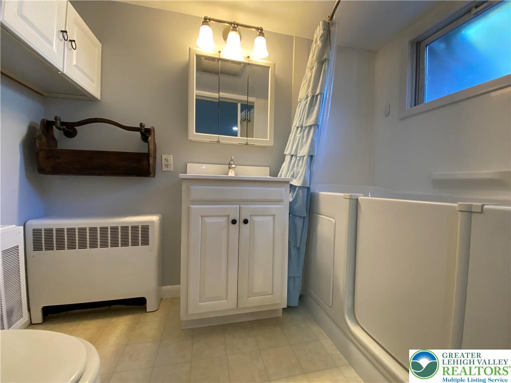 231 East Goepp Street, Unit 1 Bethlehem, PA 18018 - Photo 7 of 9 a bathroom with a toilet a sink and mirror