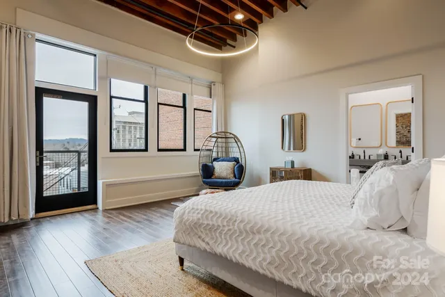 a bedroom with a large bed and a large window