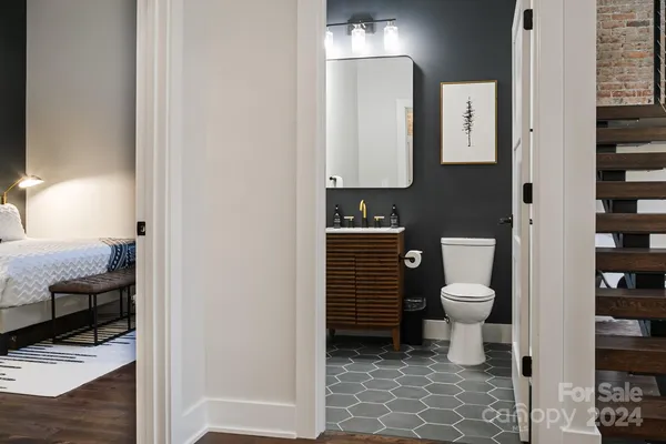 a bathroom with a toilet a sink and mirror