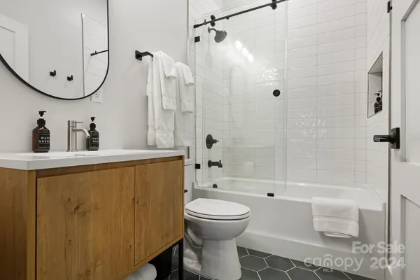 a bathroom with a sink toilet and shower