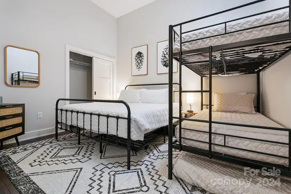 a bedroom with a bed and a chandelier