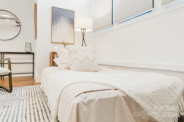 a bedroom with a bed and a mirror