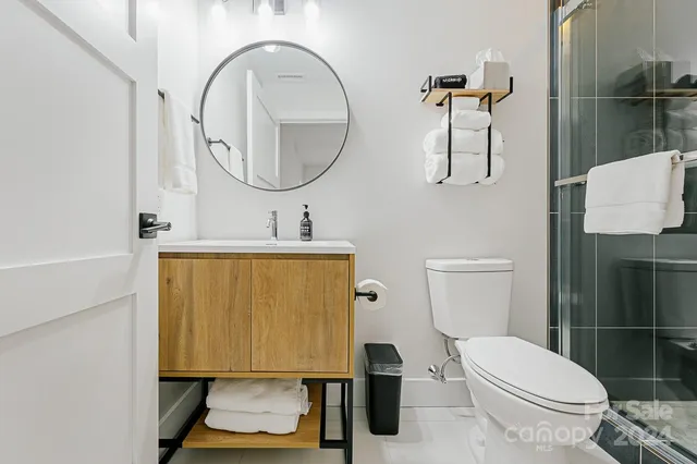 a bathroom with a sink toilet and a mirror