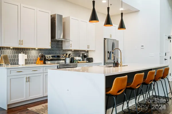 a kitchen with stainless steel appliances granite countertop a sink and cabinets