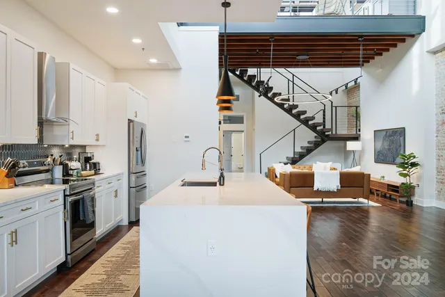 a kitchen with sink cabinets and stainless steel appliances