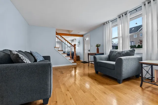 a living room with furniture and a ceiling fan