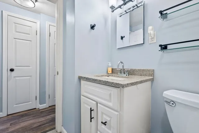 a bathroom with a granite countertop sink toilet and shower