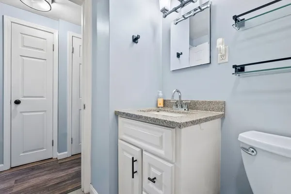 a bathroom with a granite countertop sink toilet and shower