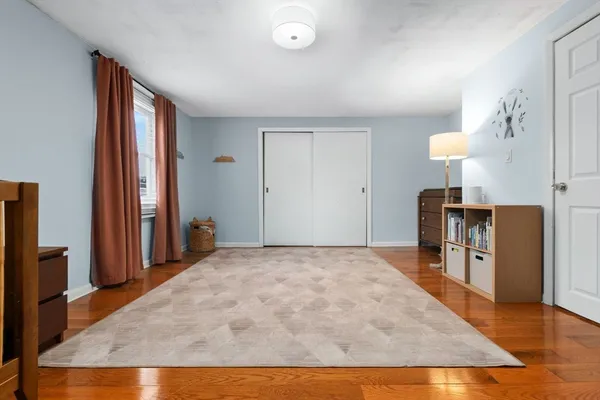 a view of a kitchen with furniture and wooden floor