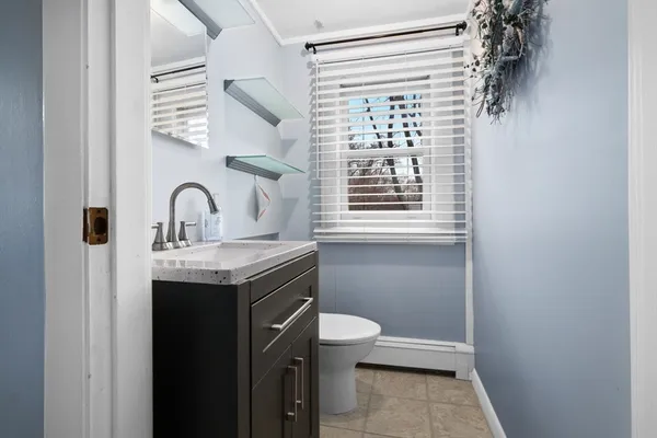 a bathroom with a granite countertop sink toilet and a shower