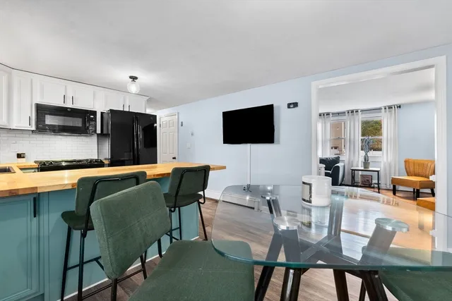a view of kitchen with cabinets table and chairs