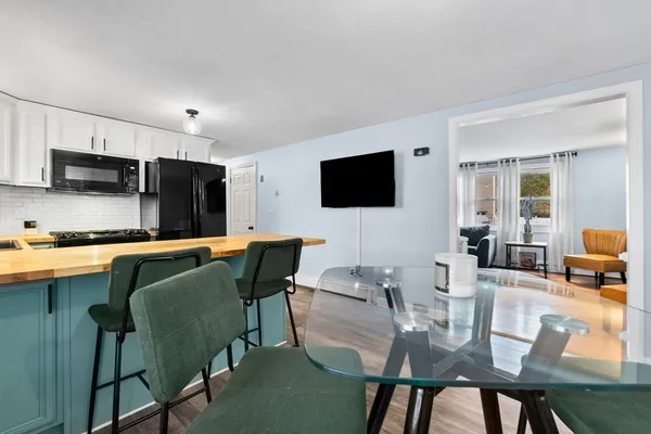 a view of kitchen with cabinets table and chairs