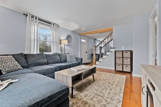 a living room with furniture and wooden floor