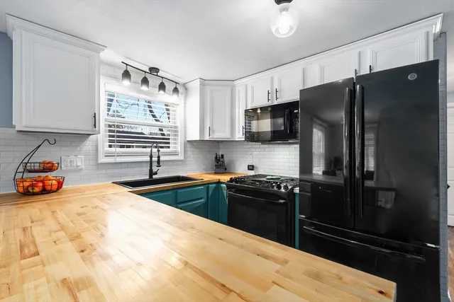 a kitchen with granite countertop a refrigerator and a sink