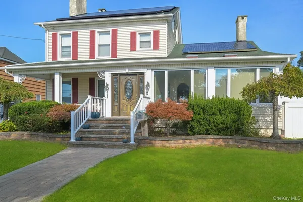 a front view of a house with garden