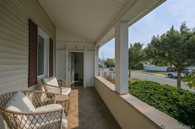 a view of a porch with furniture and garden