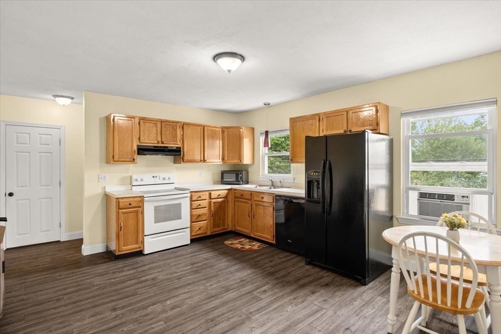 35 Hazel Street, Unit B Attleboro, MA 02703 - Photo 6 of 21 a kitchen with a refrigerator stove and wooden floor