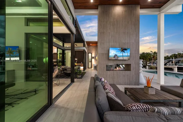 a living room with furniture and a floor to ceiling window