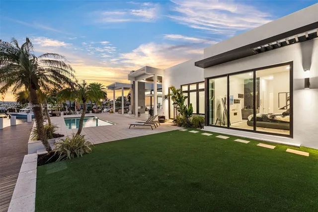 a swimming pool with outdoor seating and garden