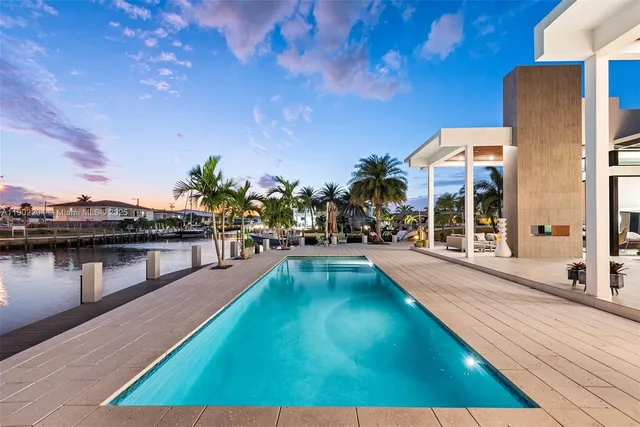 a swimming pool with outdoor seating and yard