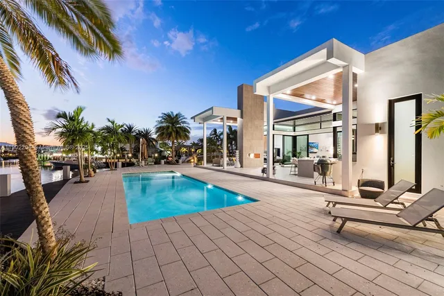 a swimming pool with outdoor seating and yard