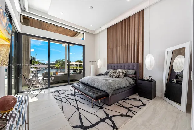 a bedroom with a bed and a large window