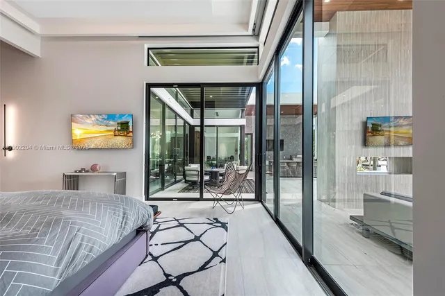 a bedroom with a bed and glass door