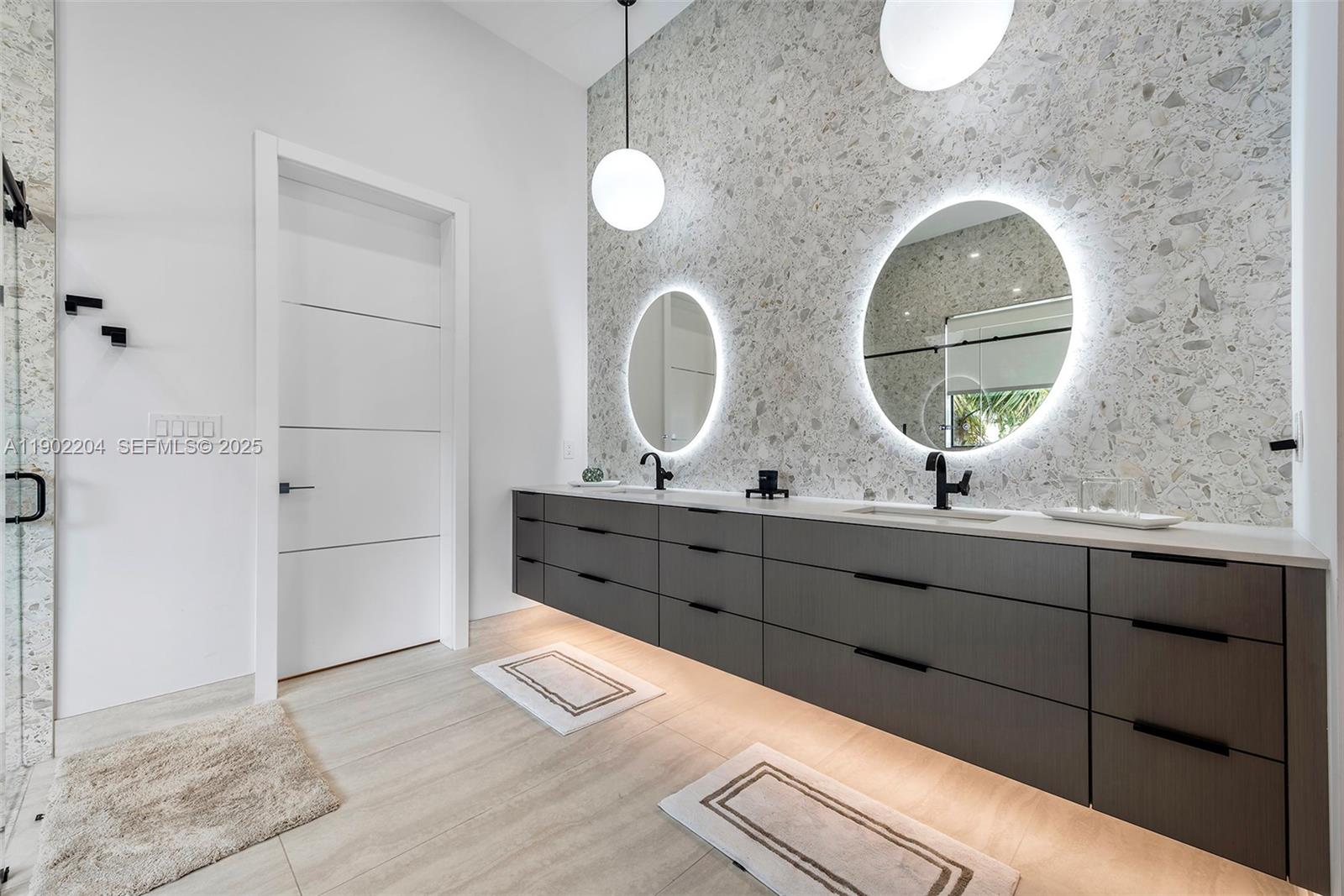 3701 Northeast 26th Avenue, Unit 1 Lighthouse Point, FL 33064 - Photo 34 of 46 a bathroom with a double vanity sink and a mirror